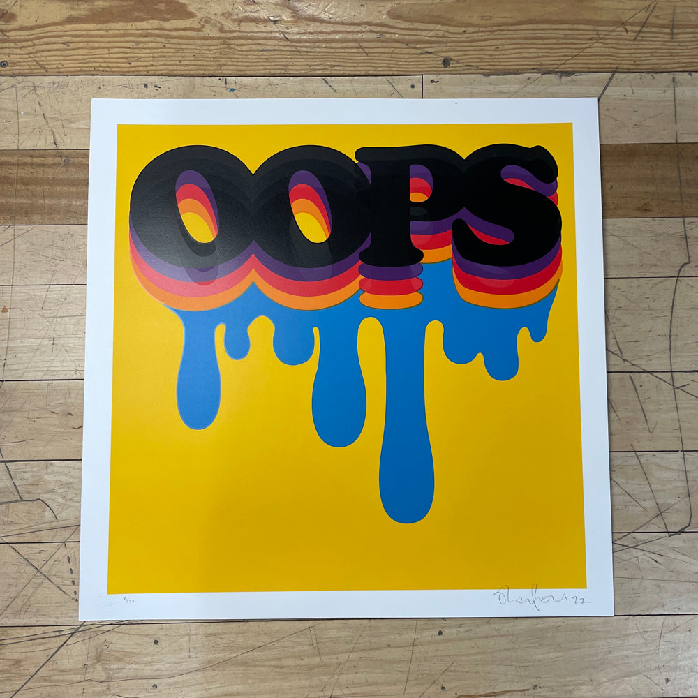 "Oops" in multi-colored dripping paint font on a yellow background