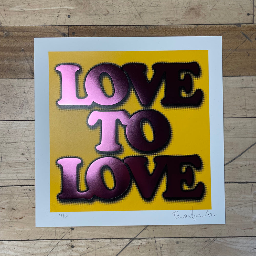 "Love to Love" in metallic purple font on a yellow background, on a white card