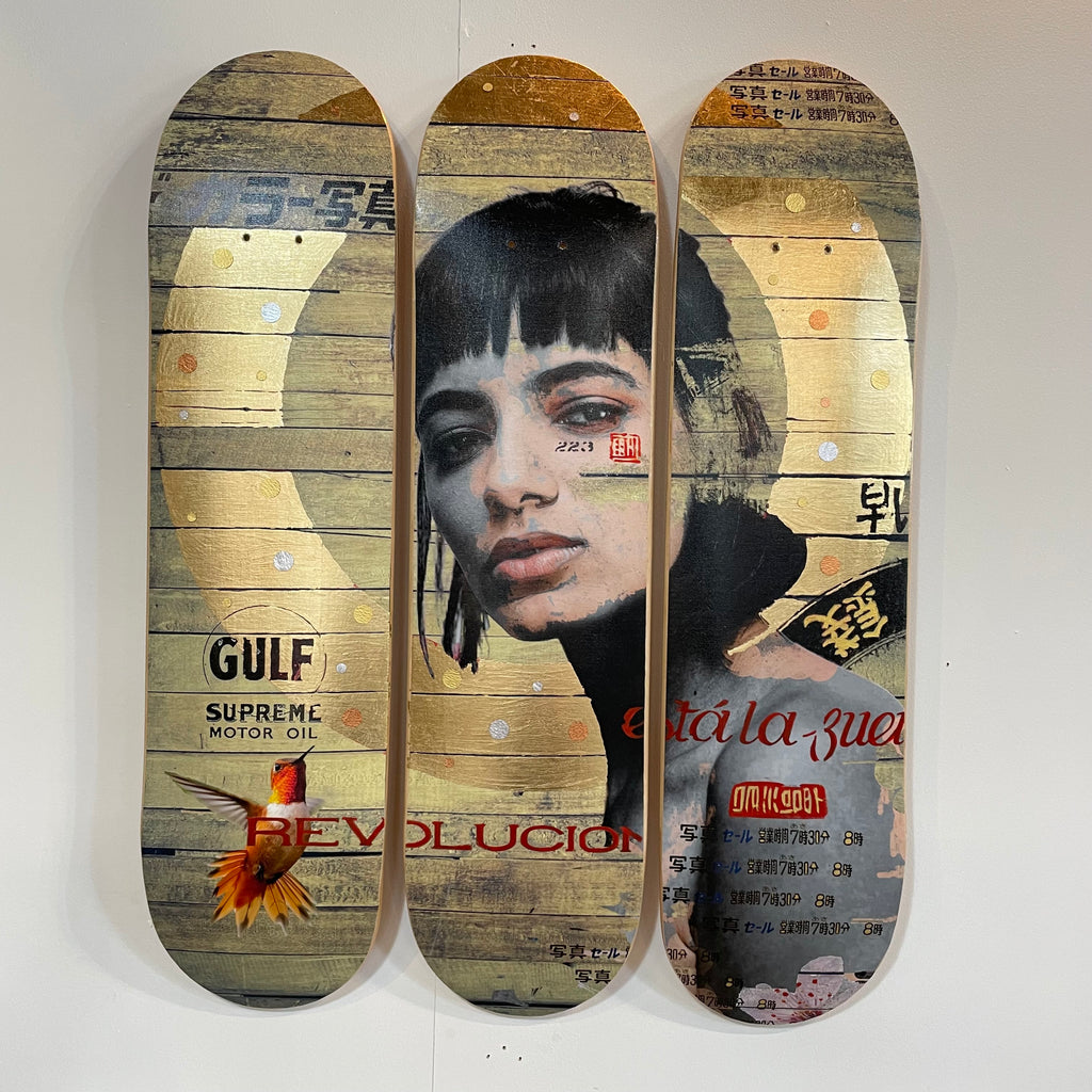Gold leaf painting of a woman with Japanese-style logos on three used skateboards