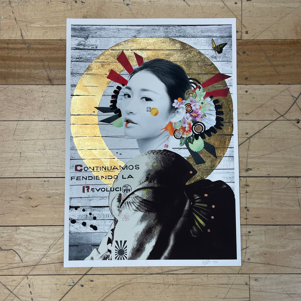 Gold leaf circle painting around an Asian woman with white face paint, looking to the side, on a grey and white wooden background